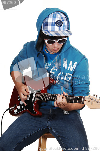 Image of Teen boy with guitar.