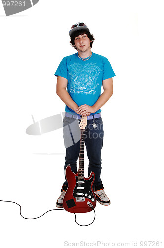 Image of Boy standing with guitar.