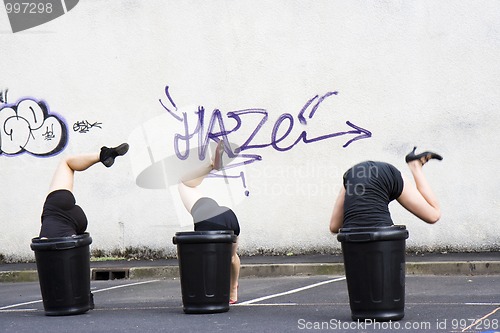 Image of Dancers, head in a garbage