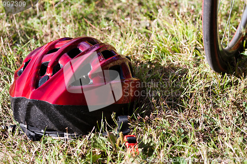 Image of Red helmet lying on the grass