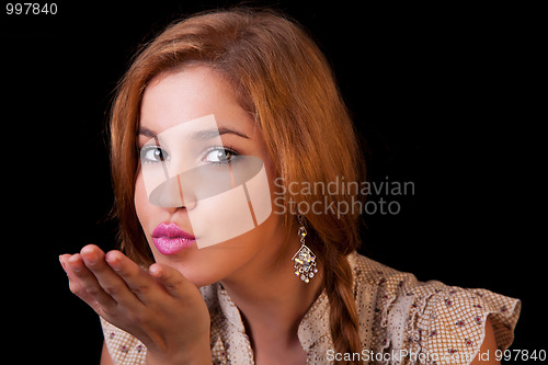 Image of Pretty young caucasian girl sending kiss, with golden reflexion