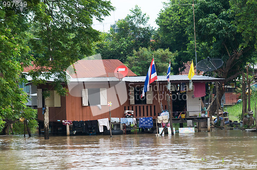 Image of House on stilts during a flood in Thailand