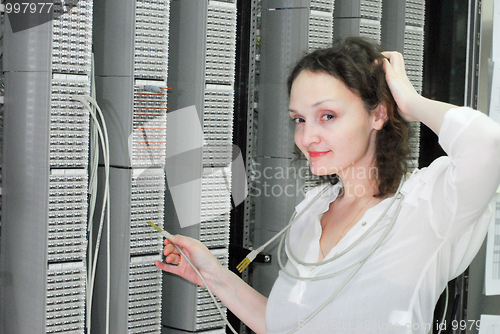 Image of Woman working on telecommunication equipment