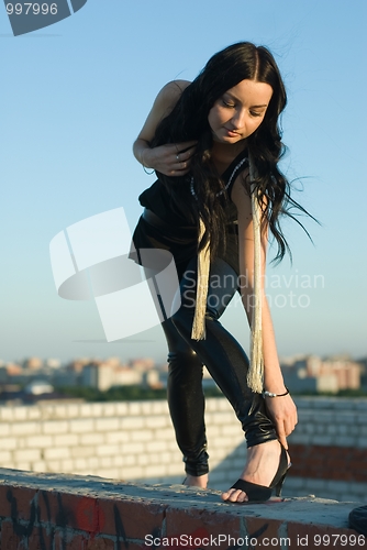 Image of The girl correcting a shoe