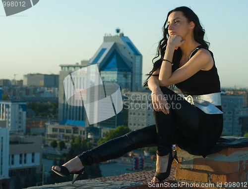 Image of Sitting girl at city background