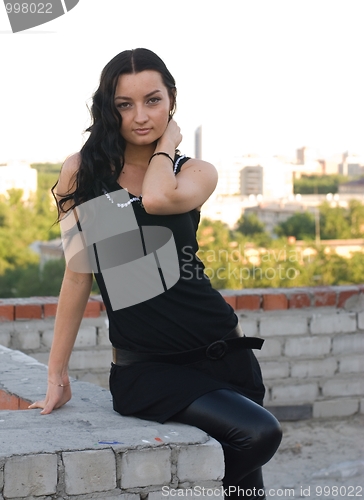 Image of Girl sitting on roof