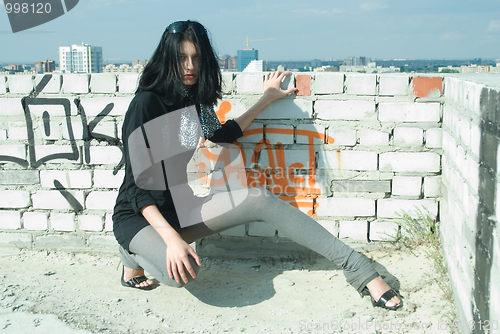 Image of Young woman on roof