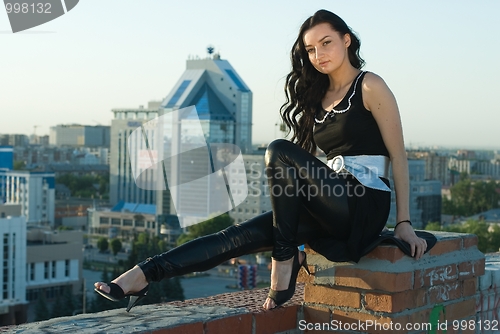 Image of Sitting girl at city background