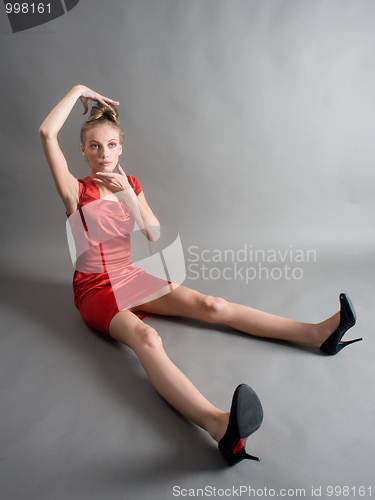 Image of Beautiful girl sitting on floor