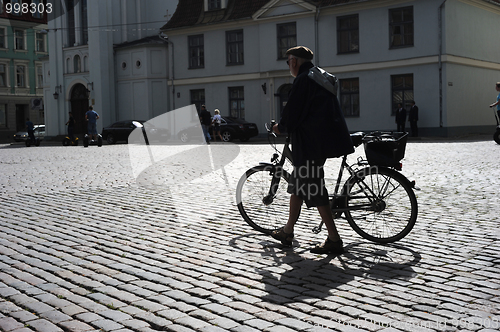 Image of Man walking his bicycle