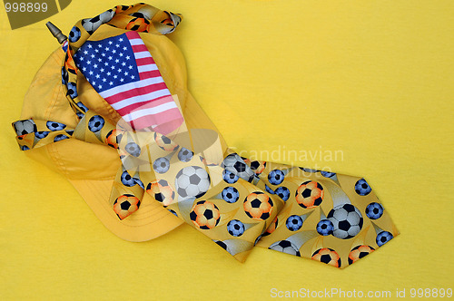 Image of Yellow Baseball Cap, Necktie and US Flag