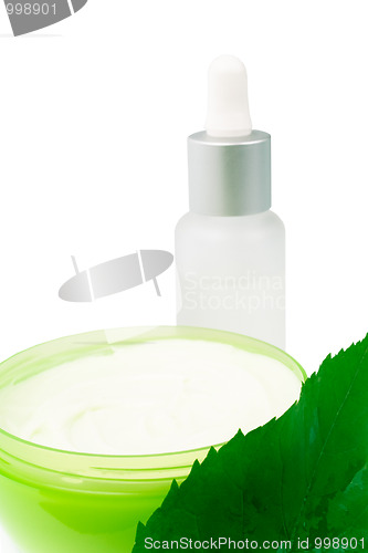 Image of cosmetic products with green leaf 