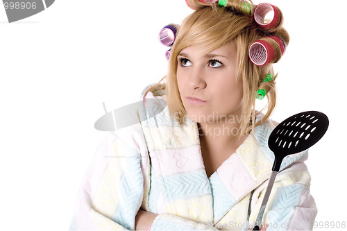 Image of  funny housewife with curlers and skimmer