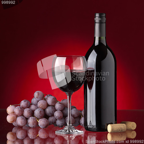 Image of Bottle and glass of red wine