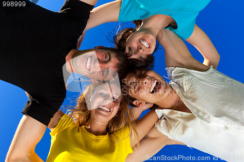 Image of The four friends, embracing, has formed a circle and bent over a