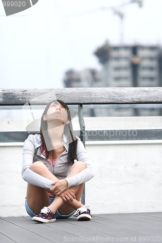 Image of depressed girl looking to the sky