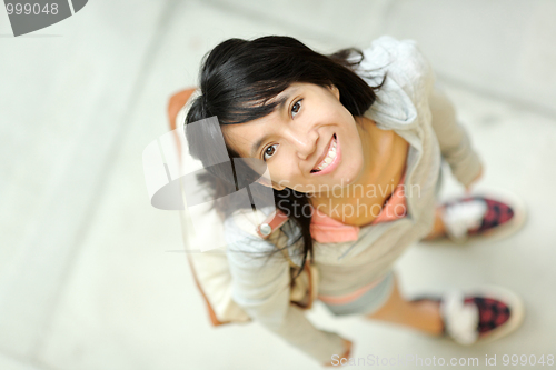Image of girl in shopping mall looking up