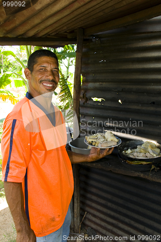 Image of native Nicaragua man freshly cooked seafood rondon rundown food 