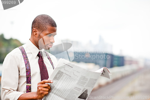 Image of Businessman reading newspaper