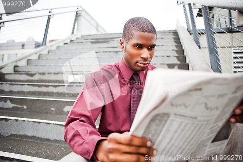Image of Businessman reading newspaper