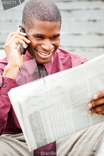 Image of Businessman reading newspaper