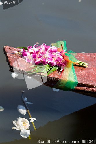 Image of Orchids on an old wooden boat in Thailand