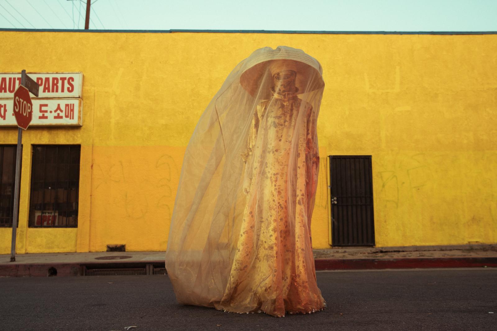 yellow building person yellow dress umbrella