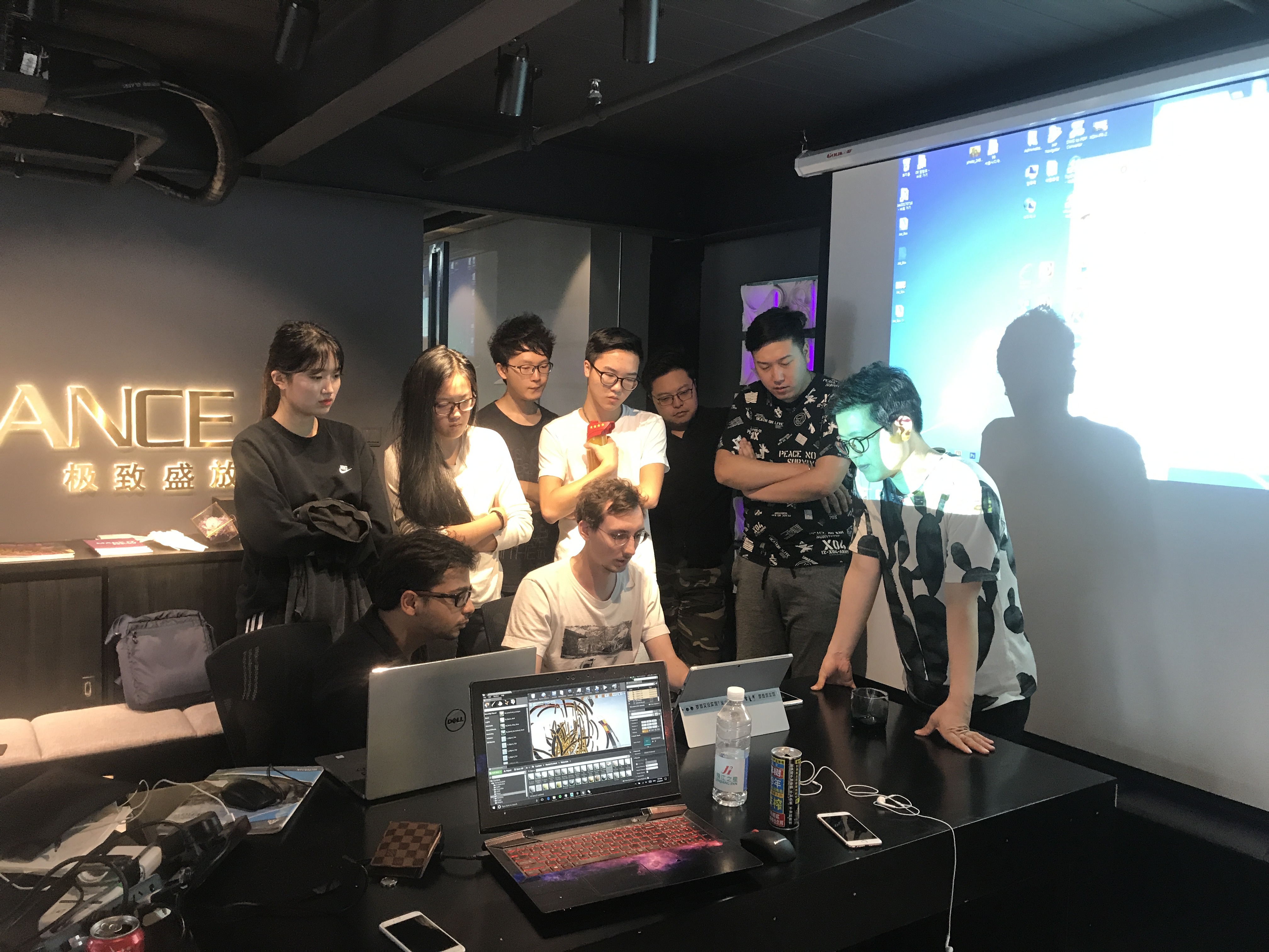 students in black studio observe computer happenings