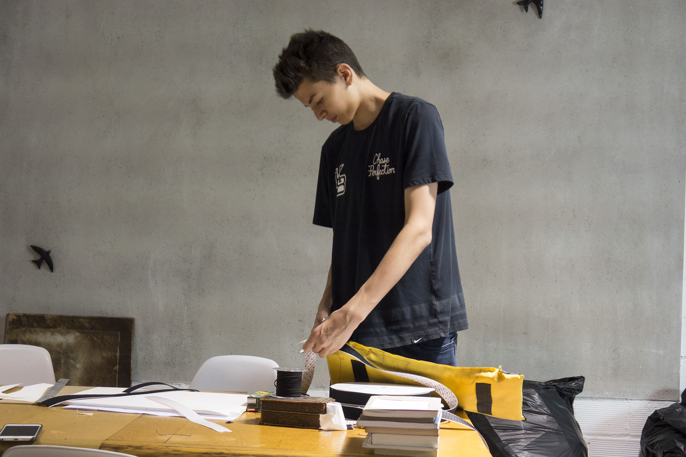 student putting together architectural model