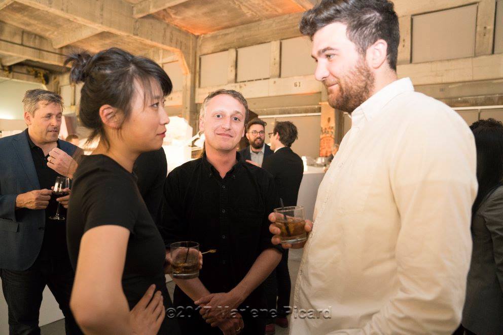 three enthusiasts in conversation over drinks