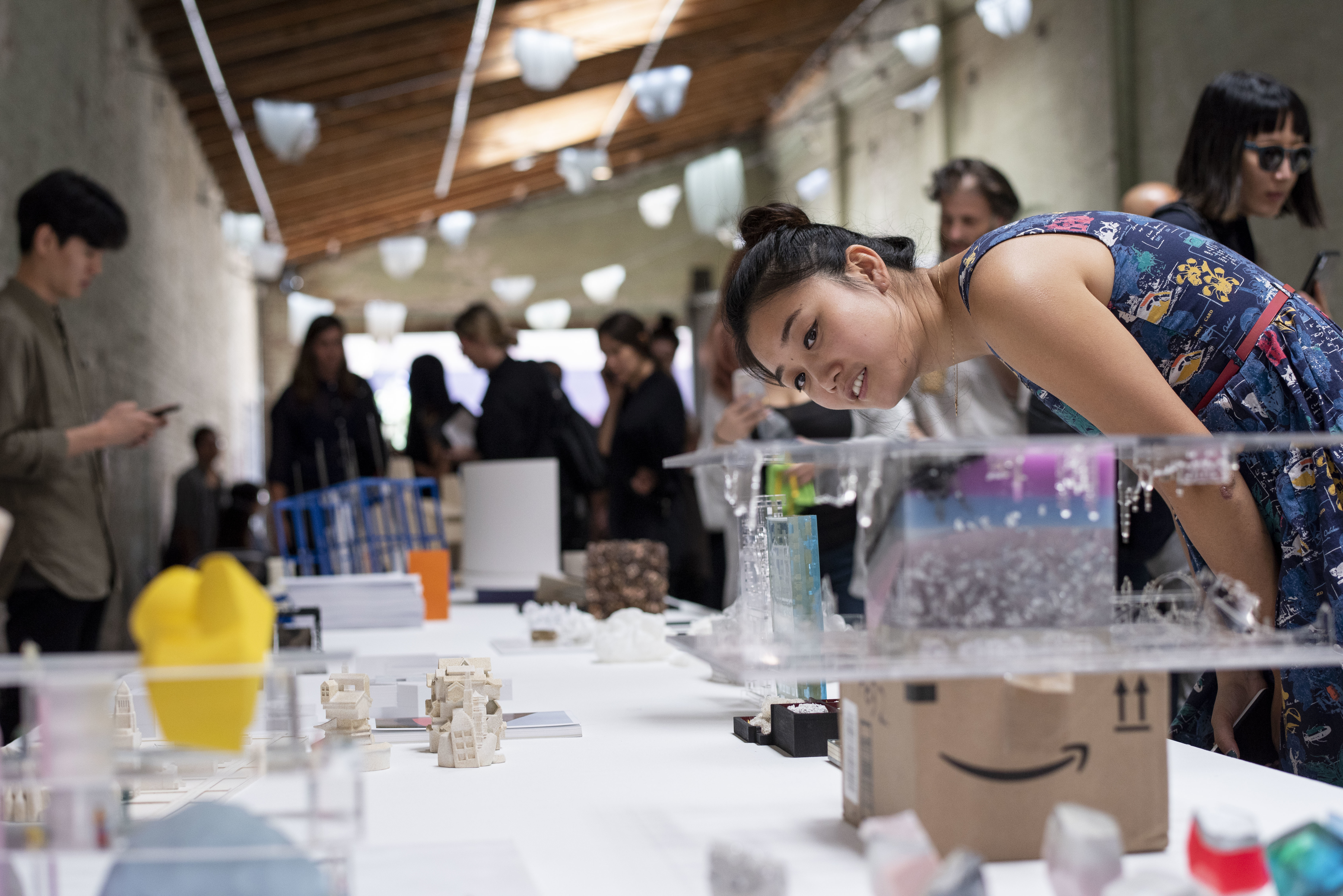 architecture enthusiast closely inspecting miniature thesis model