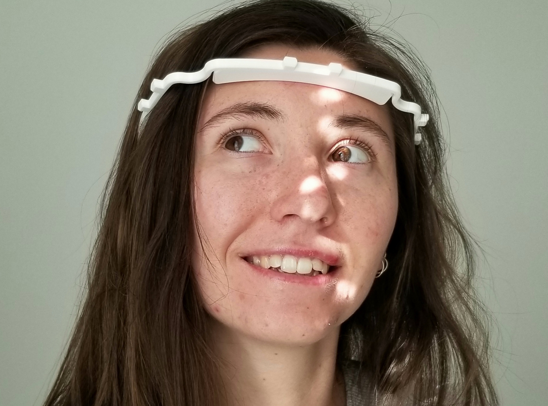 SCI-Arc student Polina Timchenko tries on face shield harness she printed.