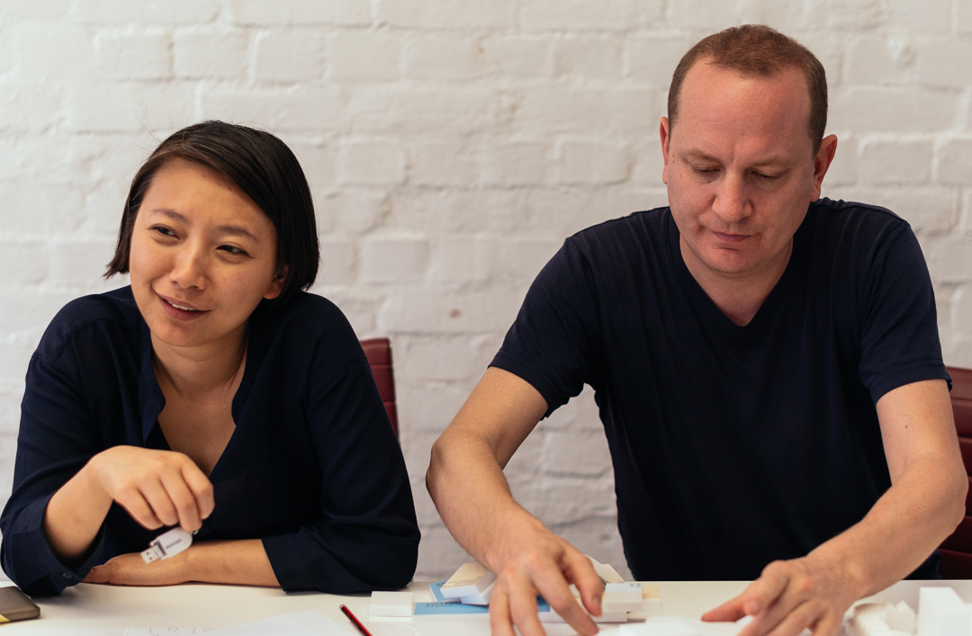 two people sitting at table woman man black shirts