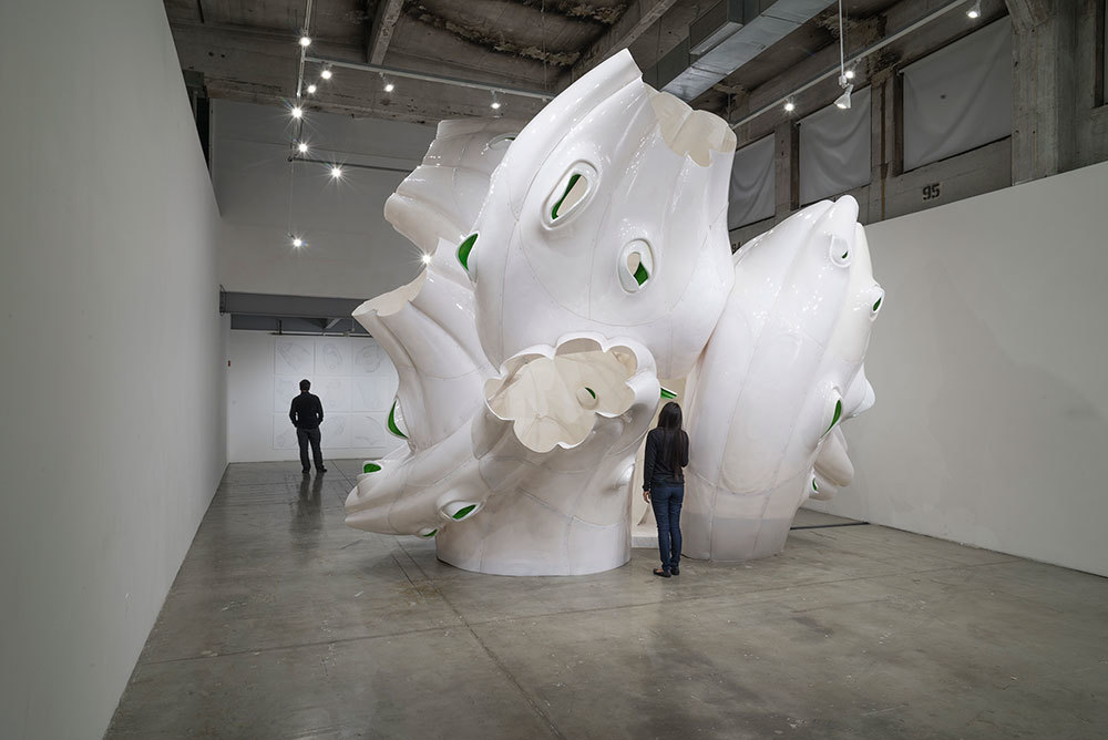 large white plastic model in gallery space