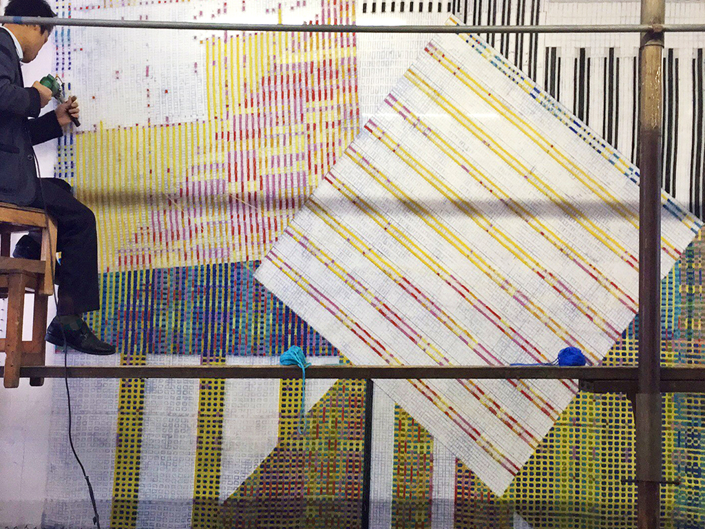 Man working on Multicolored fabrics designed by Elena Manferdini