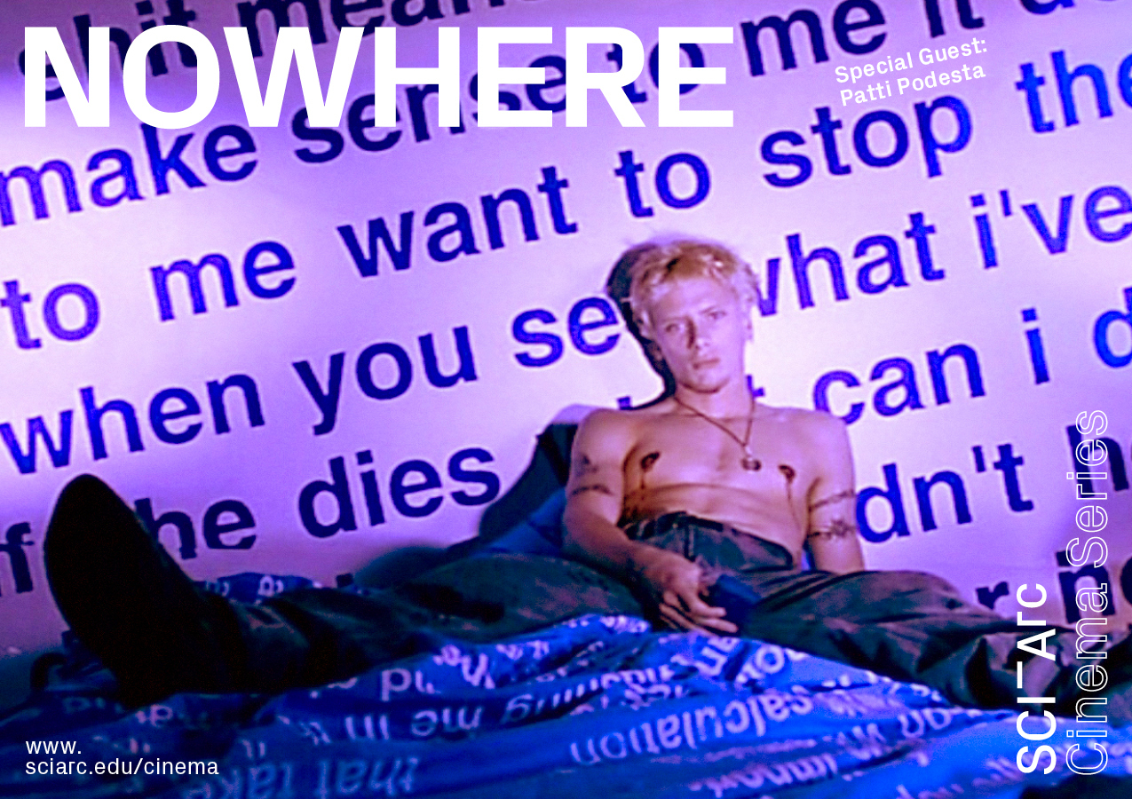 A blond boy sitting in his bed in purple lighting