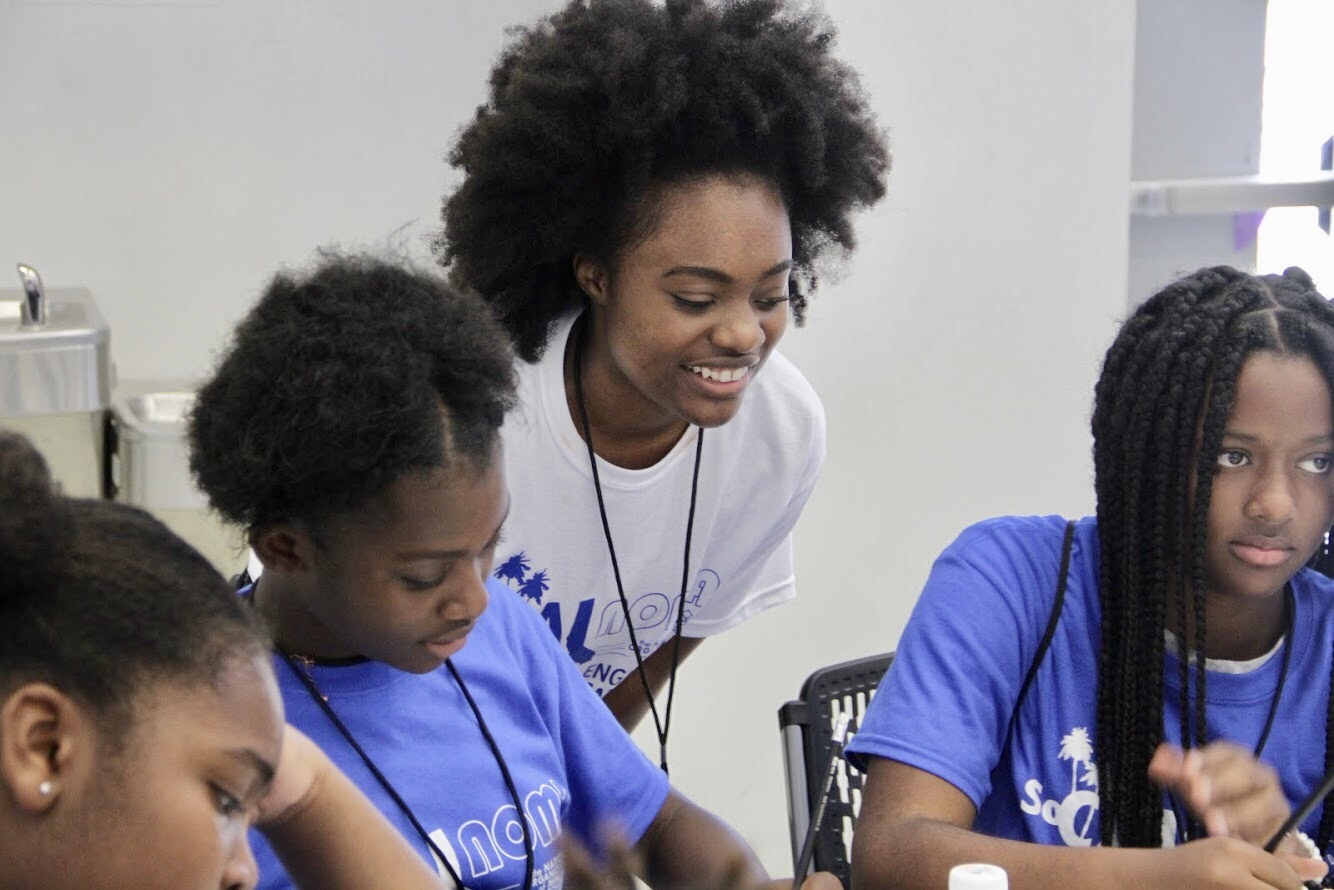 a volunteers helping out school kids