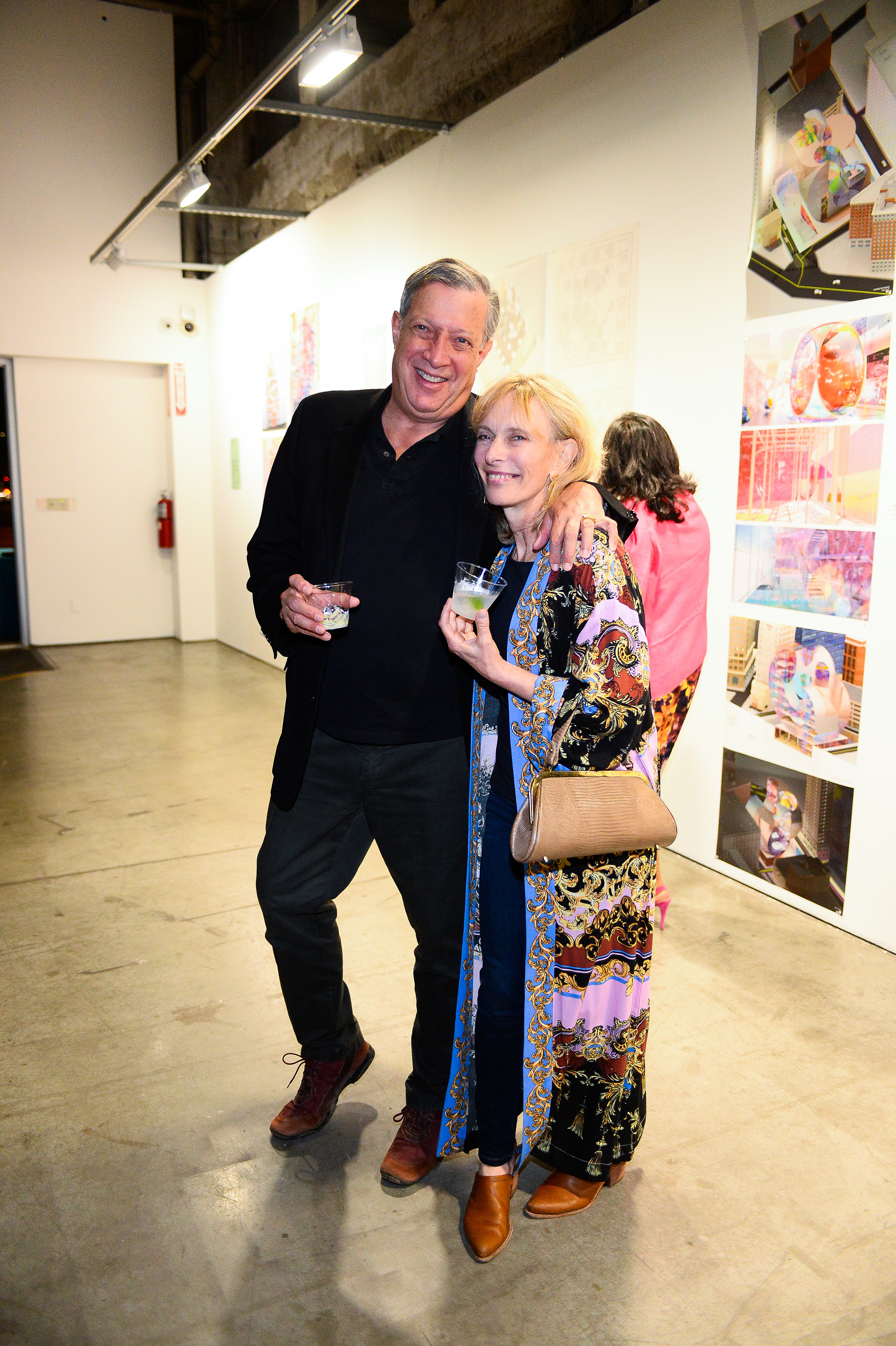 A man and a woman stand and pose for a photo together.