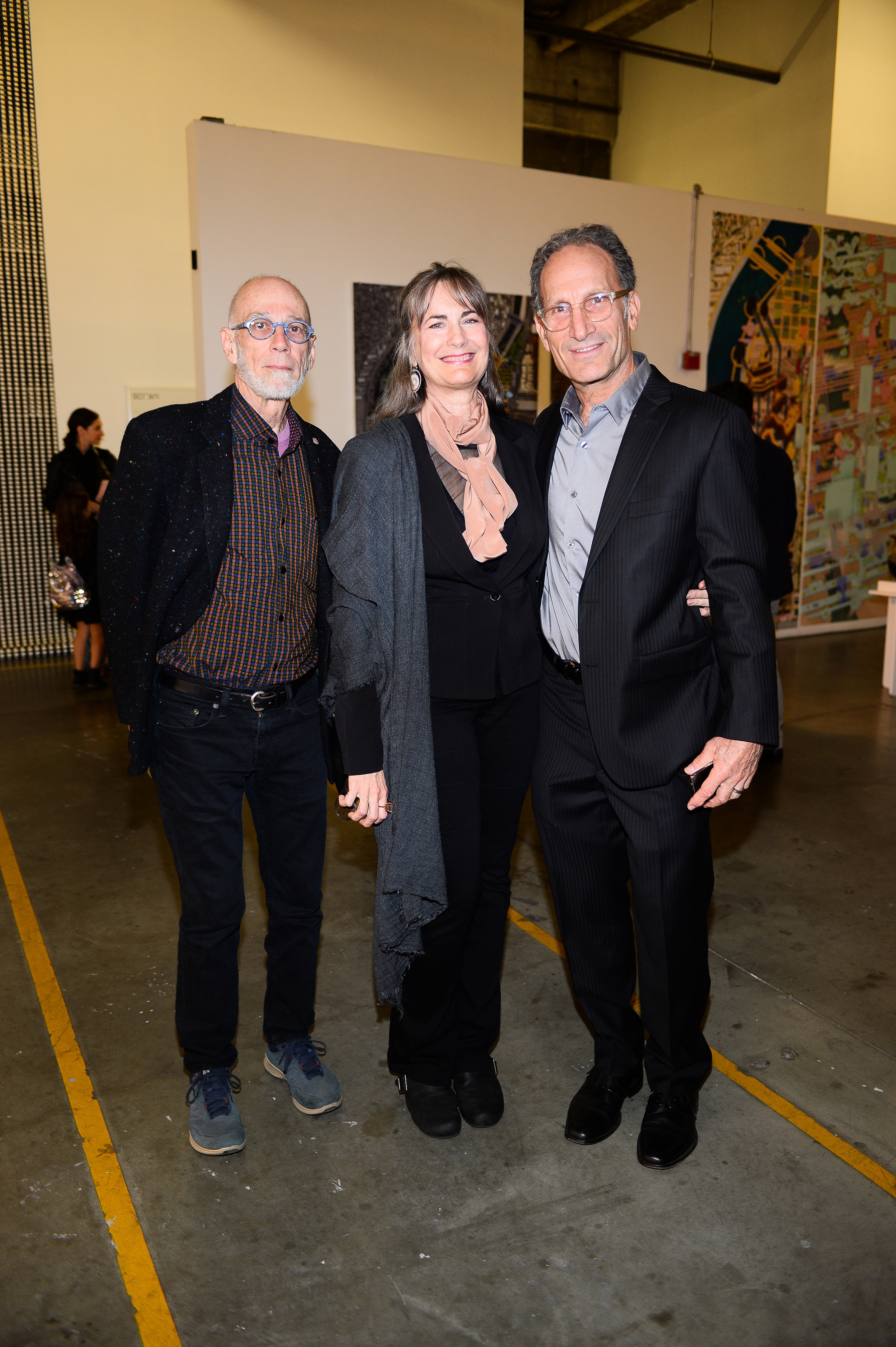 A man, a woman, and a man posing for a photo together.