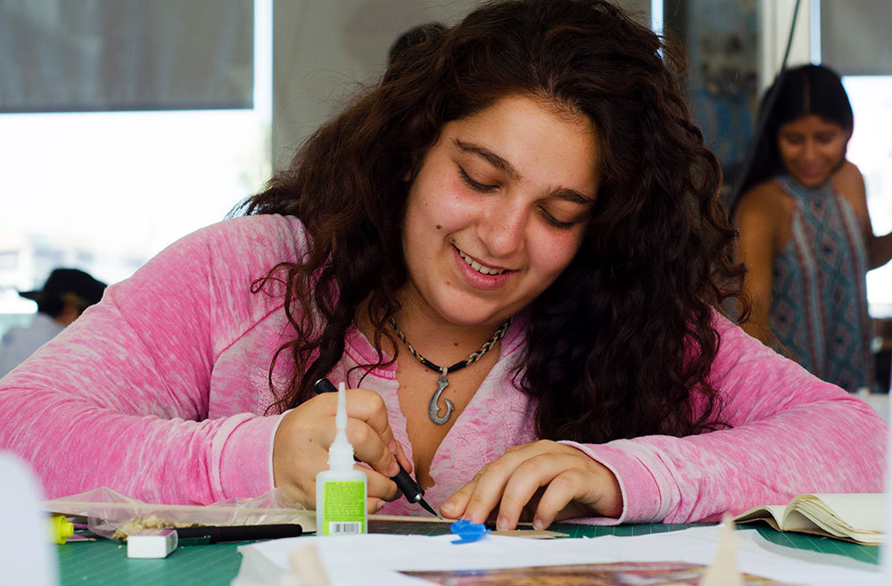 High school girl fabricating architectural model during the summer workshop