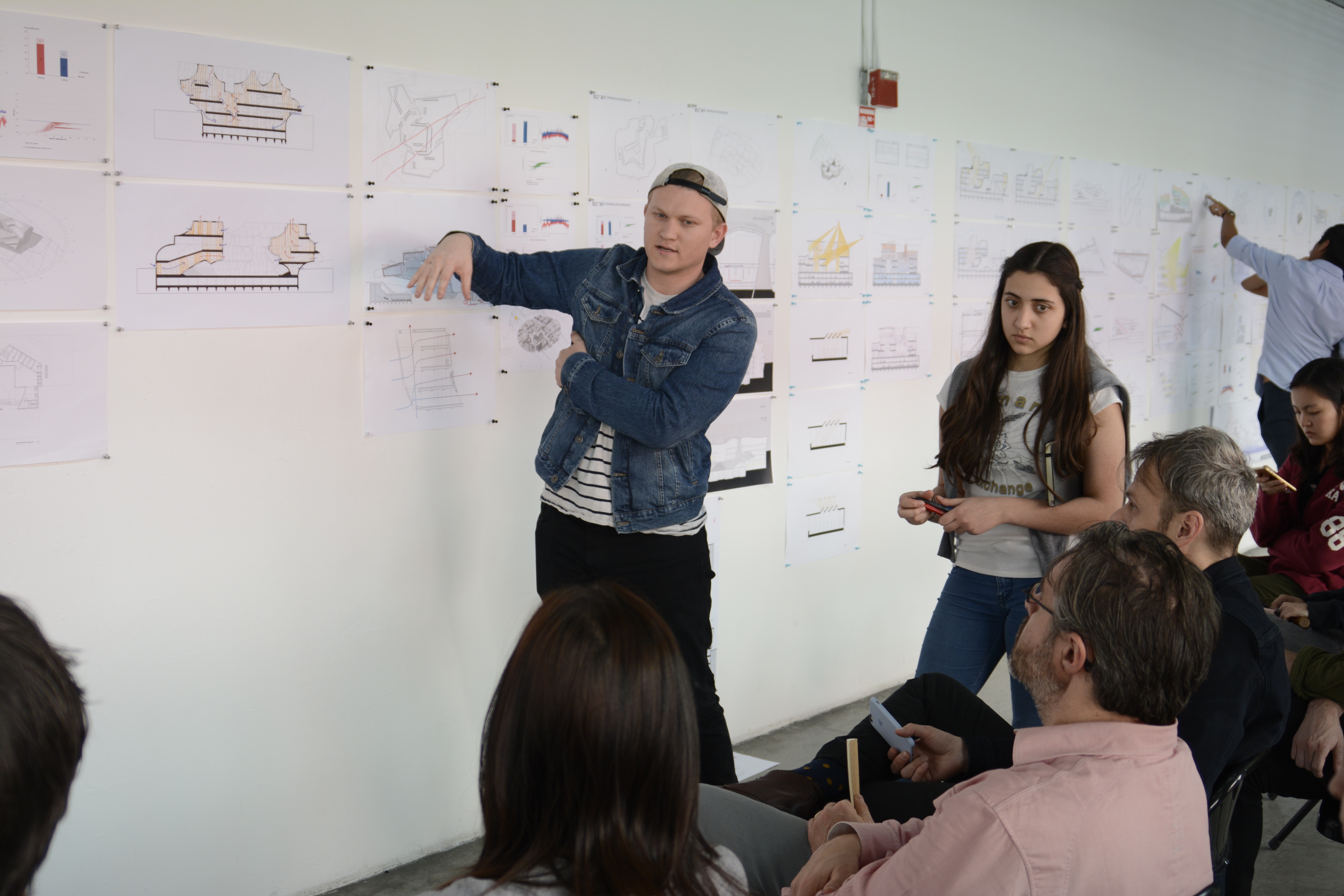 A sciarc student presenting his project to SCI-Arc faculties