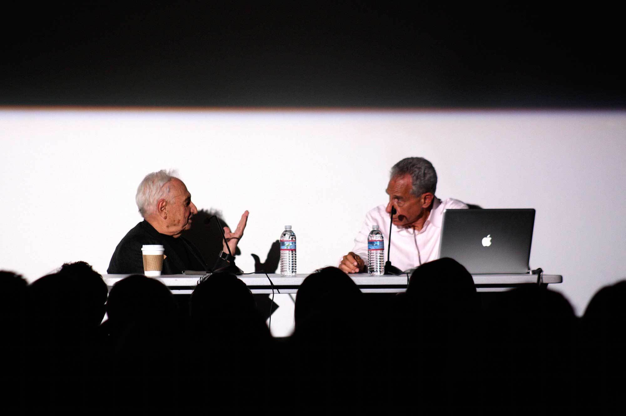 Architect Frank Gehry discussing with a Faculty member