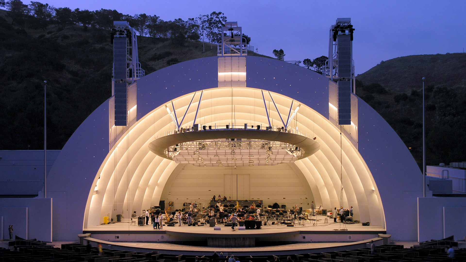 a semicircular stage dome like structure with orchestra on stage