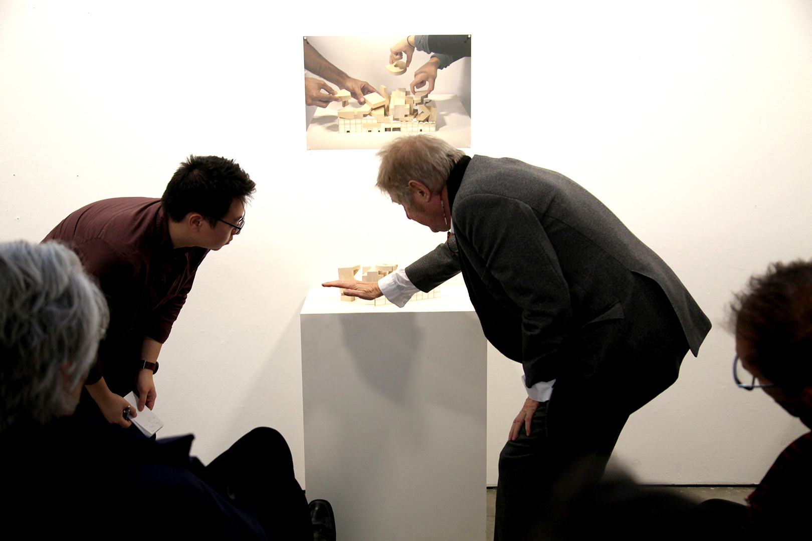 SCI-Arc faculty discussing with a student on an model during presentation