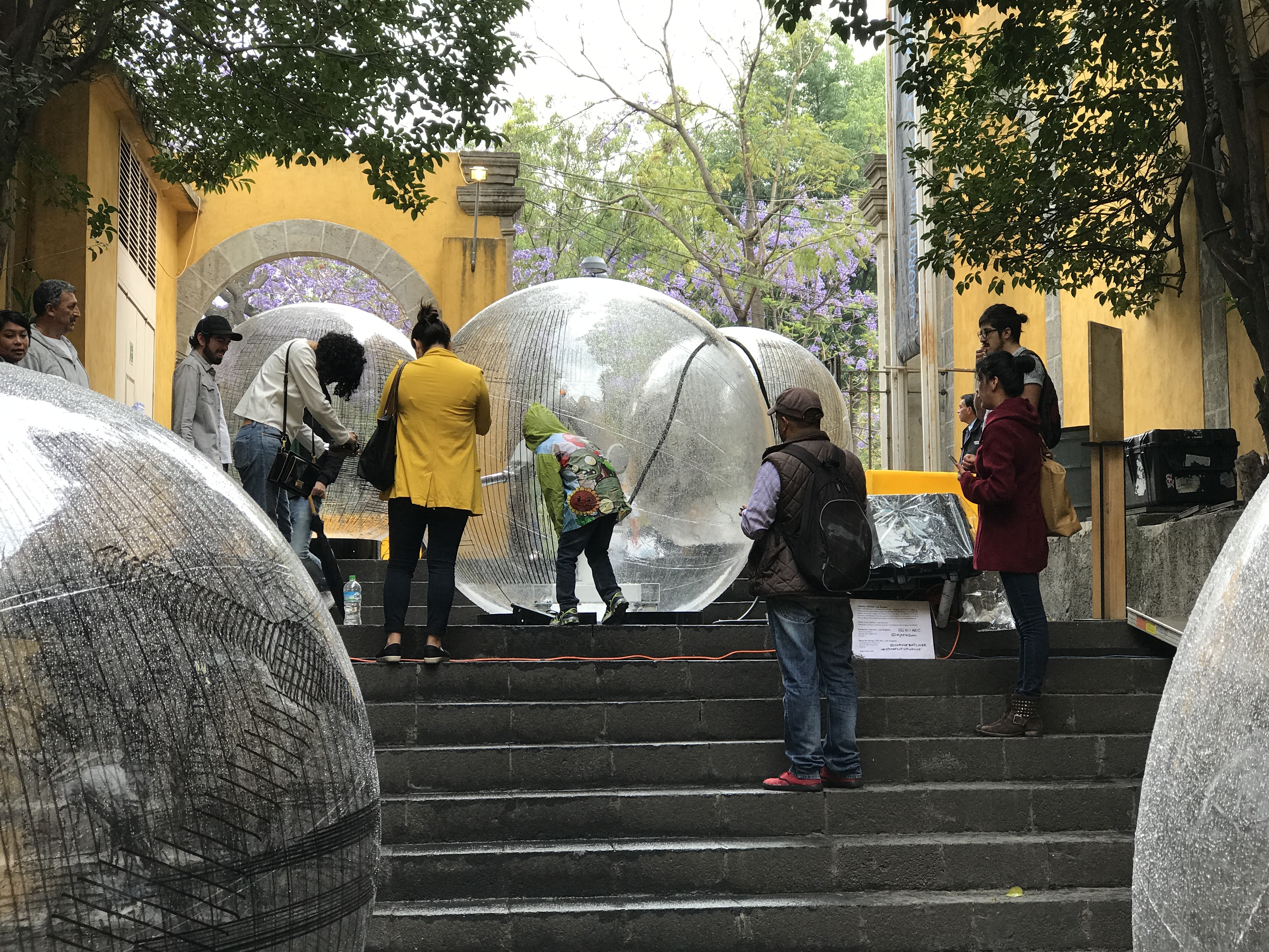 Architecture enthusiast admiring a robitic arm within clear sphere balls