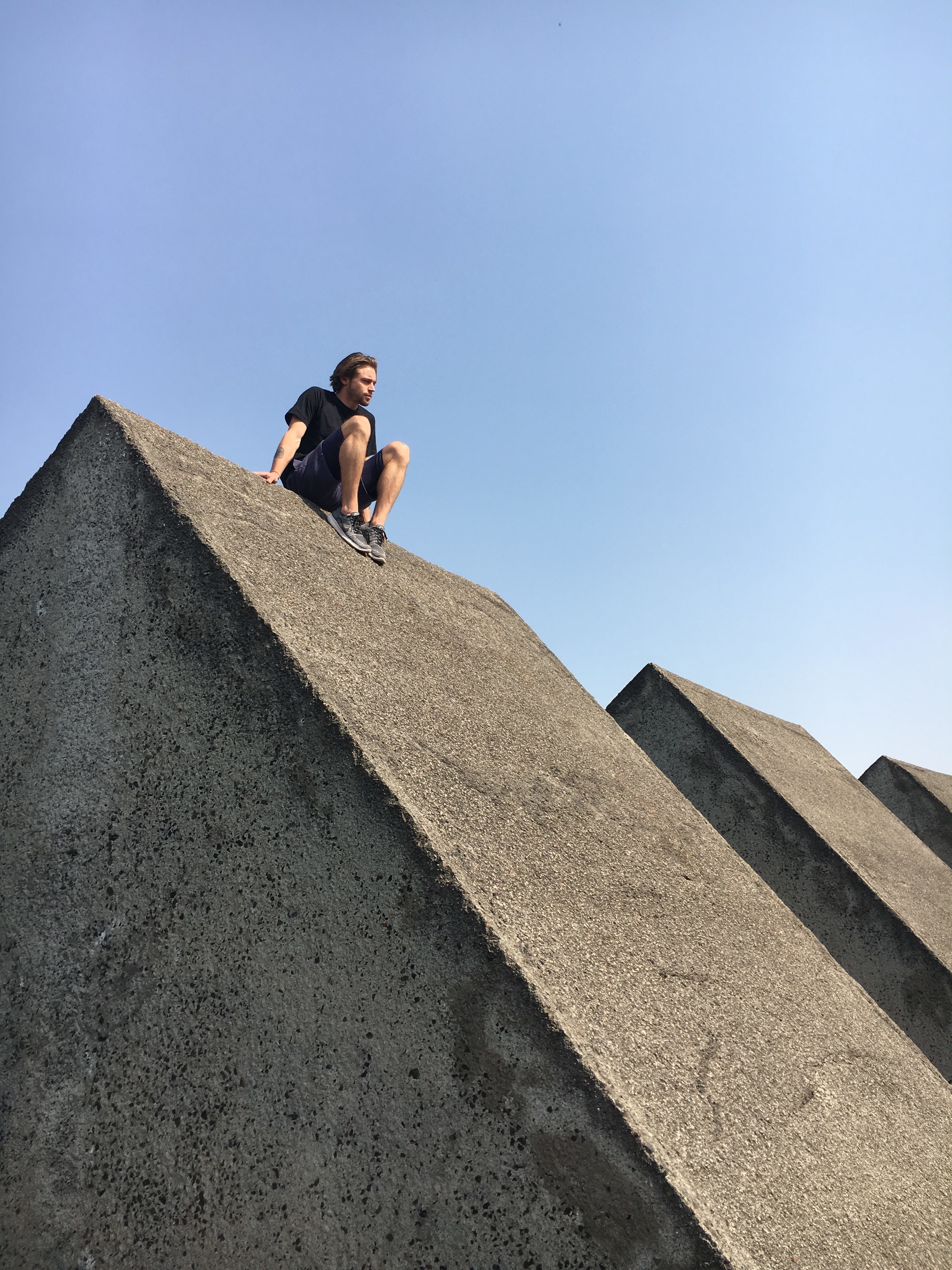 SCI-Arc student sitting over a concrete triangular structure