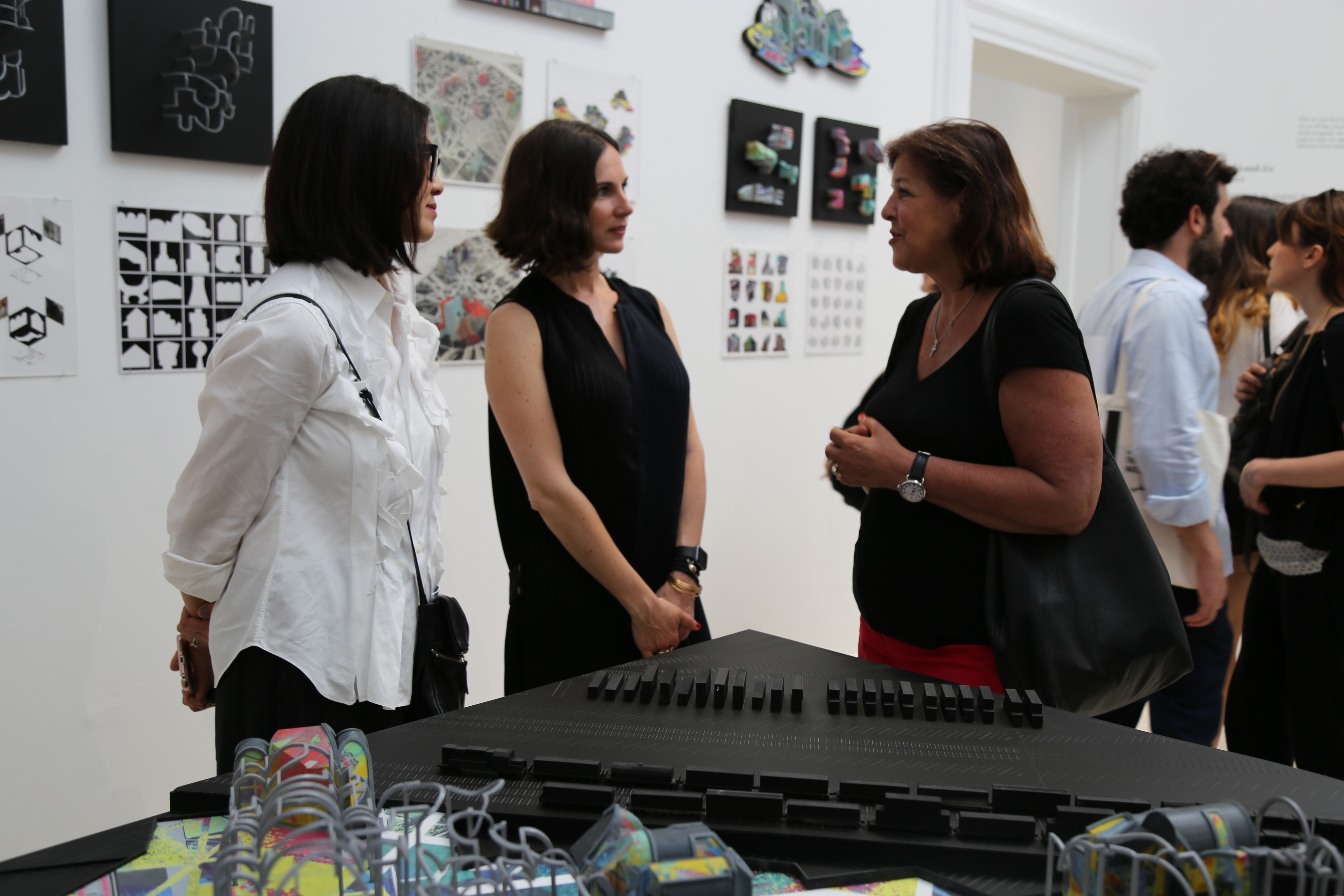 Florencia Pita and Jackie Hah Bloom talking to an architecture enthusiast