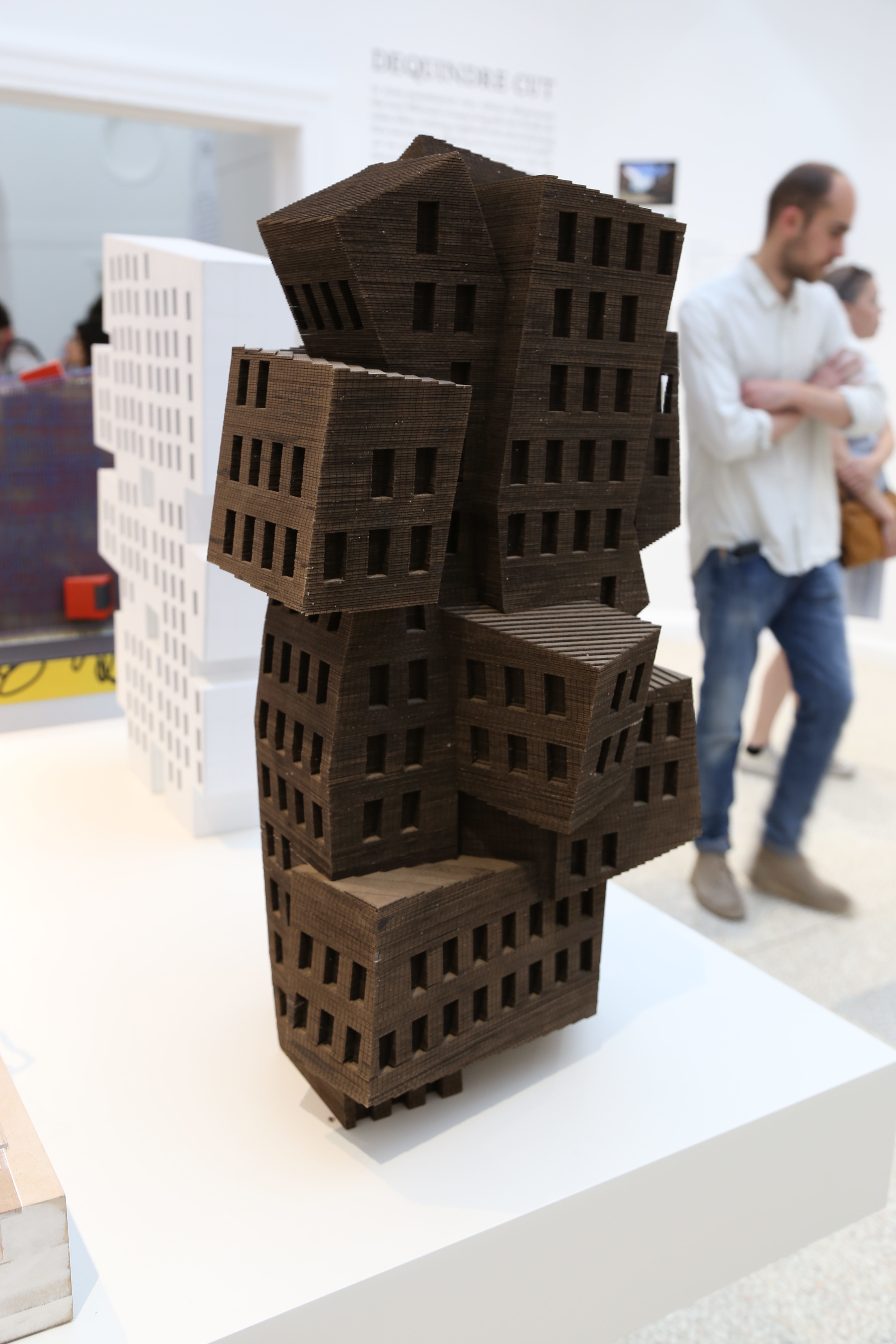 a dark brown architectural model of multiple buildings glues together