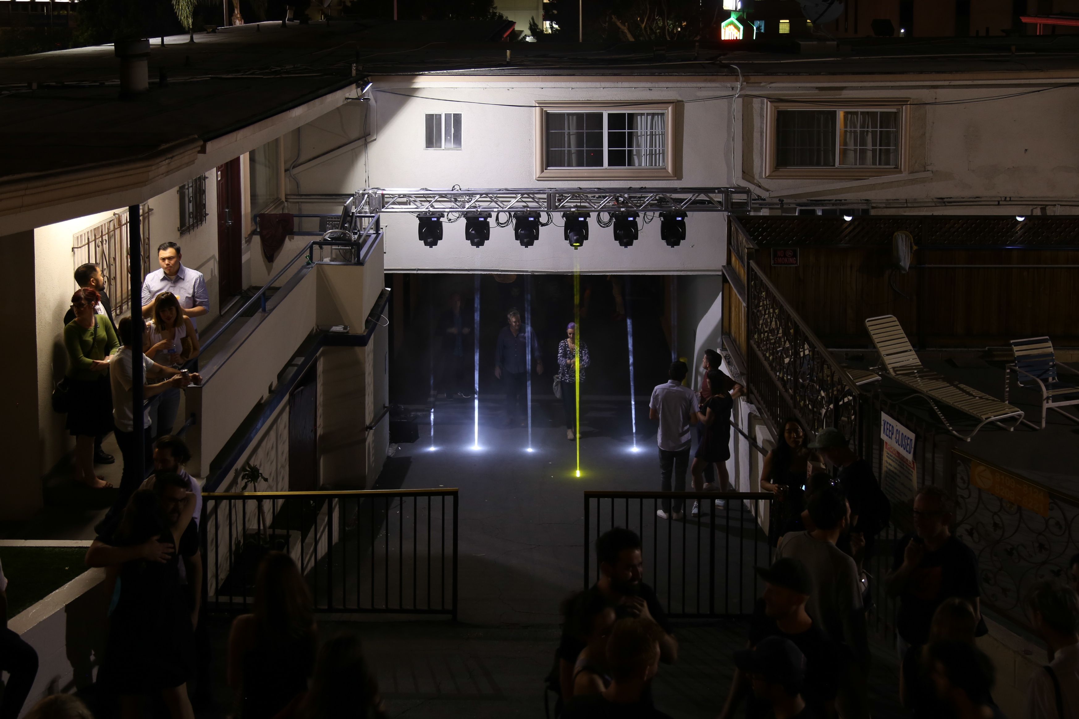 Art enthusiast admiring neon light projections at night