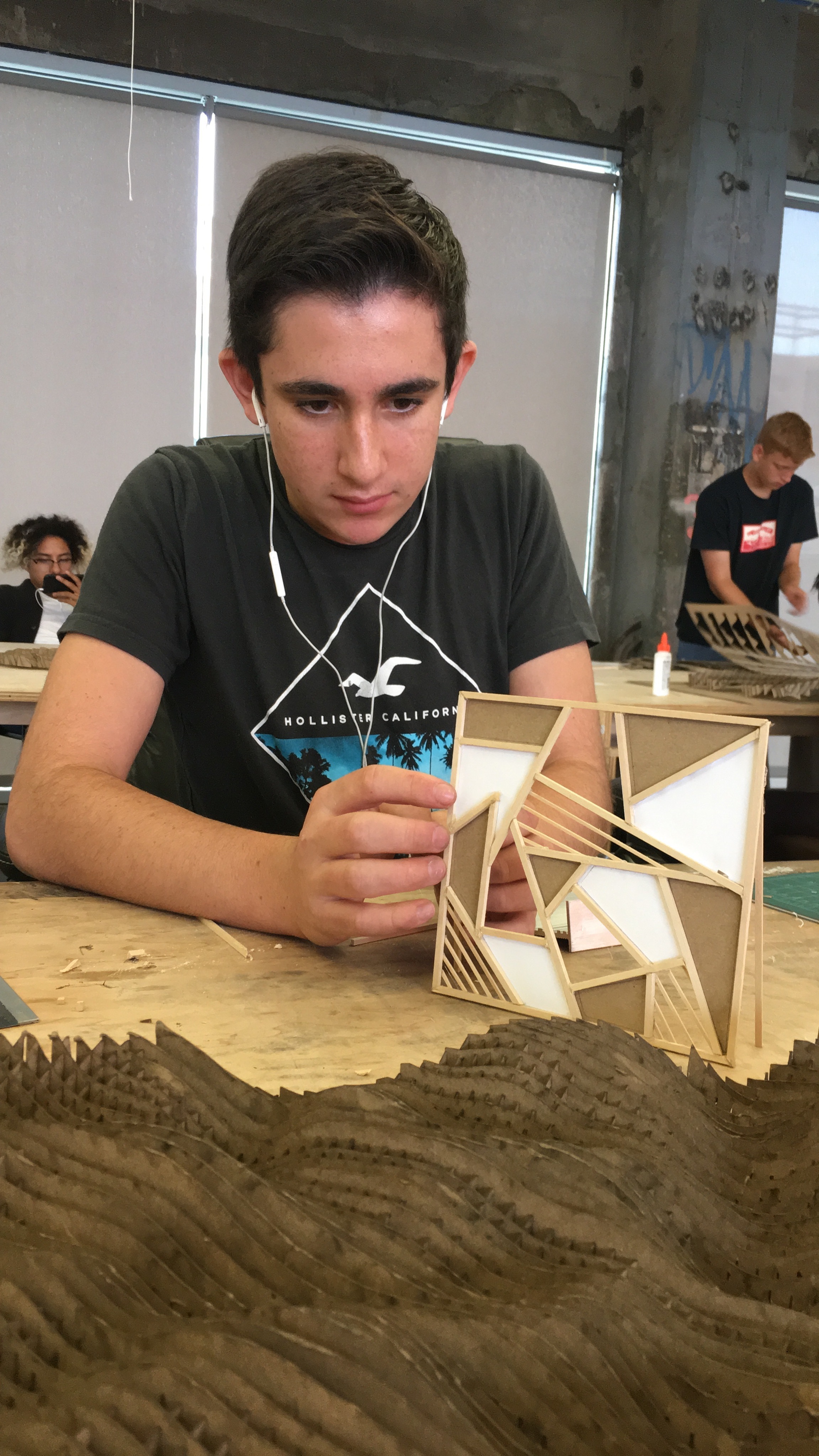 A workshop student fabricating a model